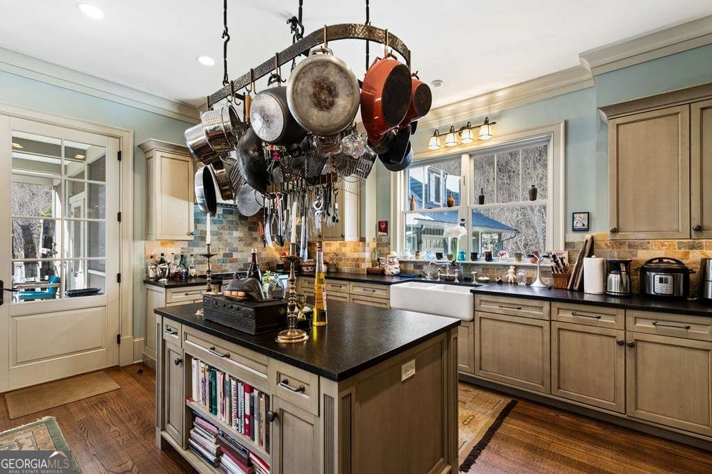 Country kitchen with island and overhead pot rack